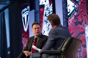 Elon Musk speaking at the Automotive News World Congress. Musk urged industry leaders to do more to advance the development of the electric car. 