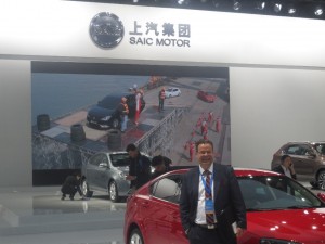 LIASE Group President and Managing Director Europe Wolfgang Doell, standing in front of the SAIC booth at the 2015 Shanghai Auto Show. SAIC unveiled a hybrid vehicle at the show. 