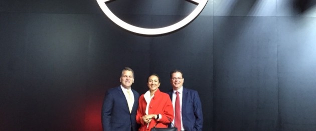 LIASE Group Managing Director for the Americas John Bukowicz (left), LIASE Group Managing Director Asia Vanessa Moriel (center) and LIASE Group President and Managing Director Europe Wolfgang Doell (right) standing in front of the Mercedes-Benz logo at the Frankfurt Motor Show.