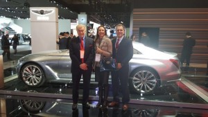 Left to right: Vic H. Doolan, Non-Executive Member of the Board, LIASE Group; Vanessa Moriel, Managing Director Asia, Liase Group; and, John Bukowicz, Managing Director for the Americas, LIASE Group, pose in front of new the new Genesis G90 luxury car by Hyundai.