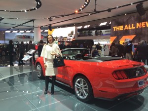 Vanessa Moriel, Managing Director Asia, Liase Group poses for a picture next to a convertible Ford Mustang. 