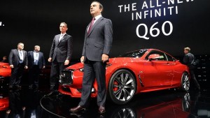 Nissan CEO Carlos Ghosn standing in front of the company’s latest Infiniti Q60 sports sedan. 