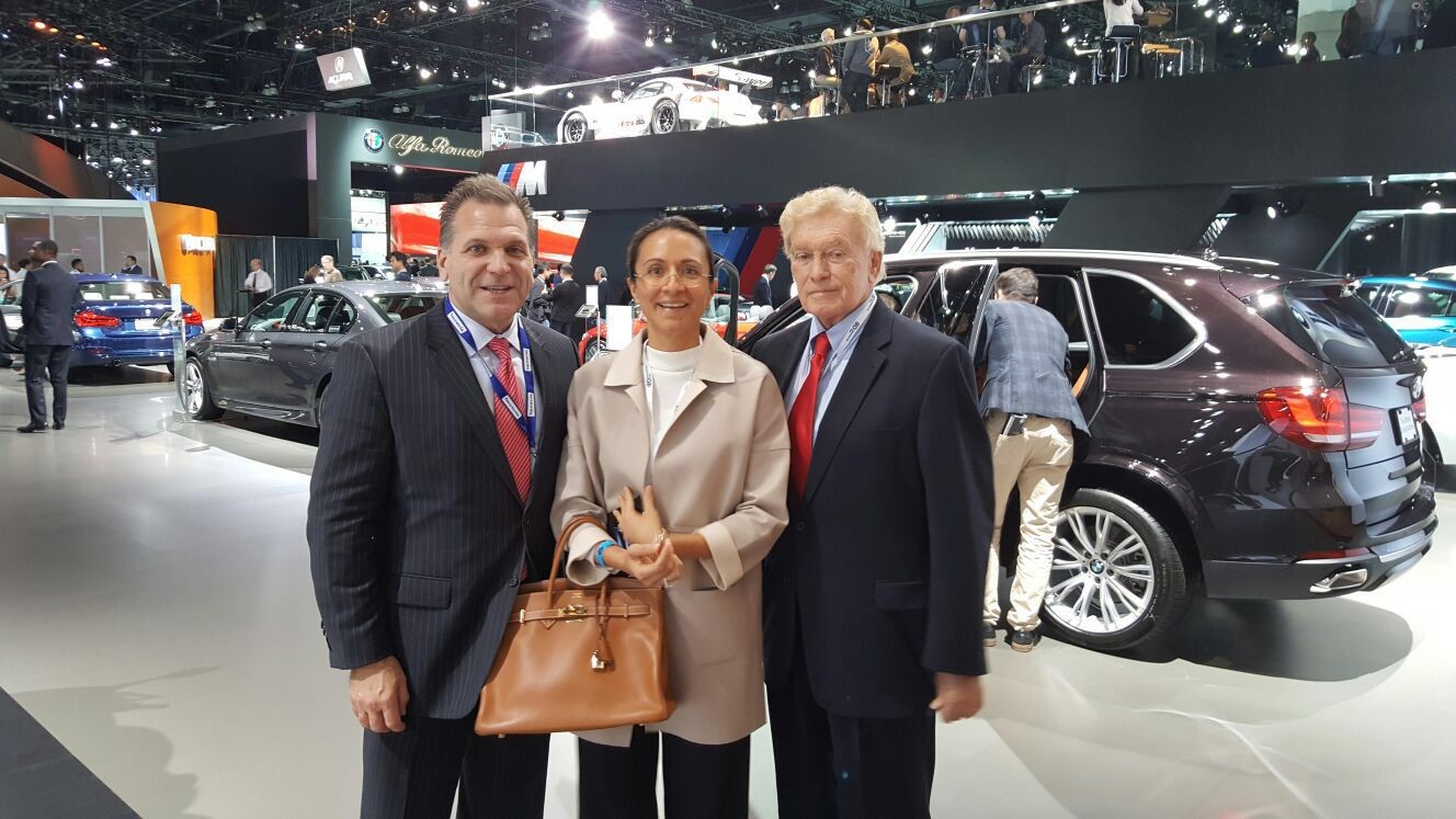 The LIASE Group’s John Bukowicz, Managing Director for the Americas (left), Vanessa Moriel, Managing Director Asia (right) and Vic H. Doolan, Non-Executive Member of the Board, take a picture at the LA Auto Show.