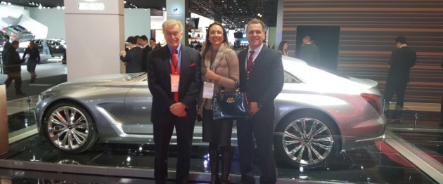 Left to right: Vic H. Doolan, Non-Executive Member of the Board, LIASE Group; Vanessa Moriel, Managing Director Asia, Liase Group; and, John Bukowicz, Managing Director for the Americas, LIASE Group, pose in front of new the new Genesis G90 luxury car by Hyundai.